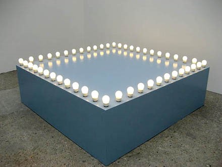 Félix González-Torres, Untitled (Go-Go Dancing Platform), 1991, Wood, light bulbs, acrylic paint and Go-Go dancer in silver lamé bathing suit, sneakers and personal listening device. © The Felix Gonzalez-Torres Foundation. Courtesy Andrea Rosen Gallery, New York.