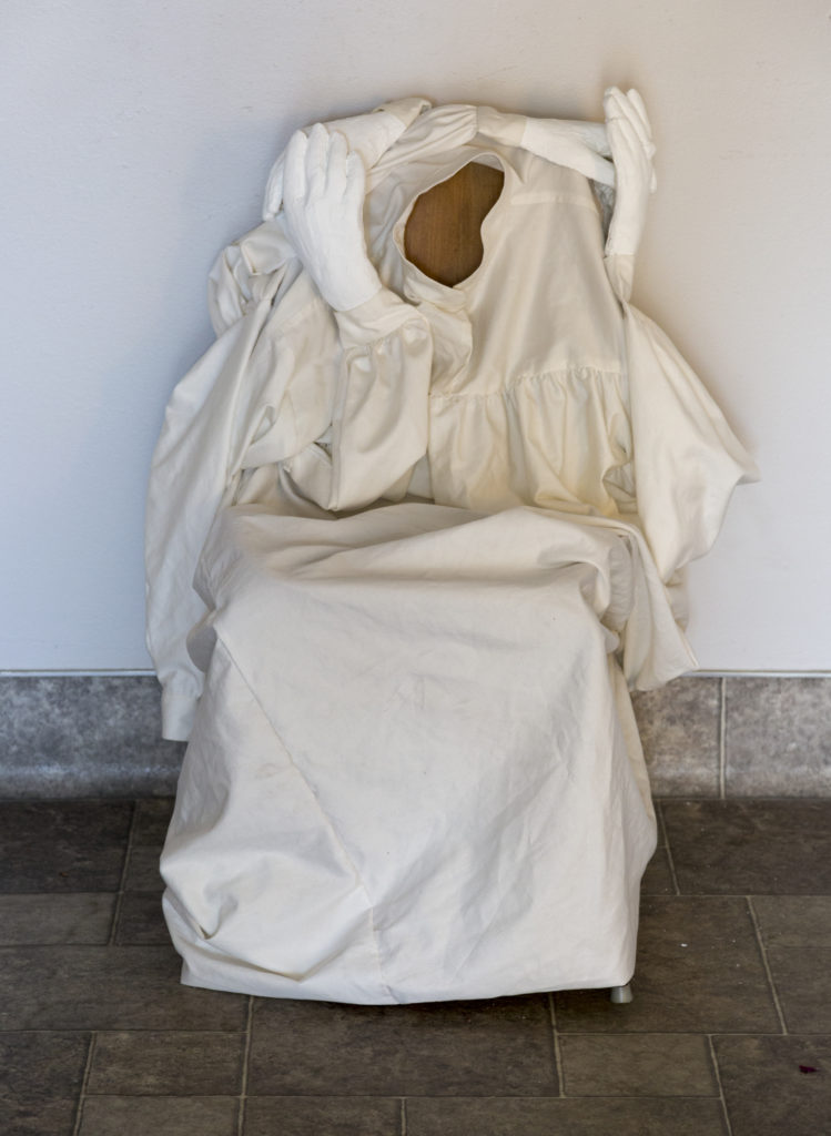 At the Threshold, 2022, plaster, lockdown sheets, chair, Quality Coins, Yucca Valley, CA. Image courtesy of Sarah Lyon.