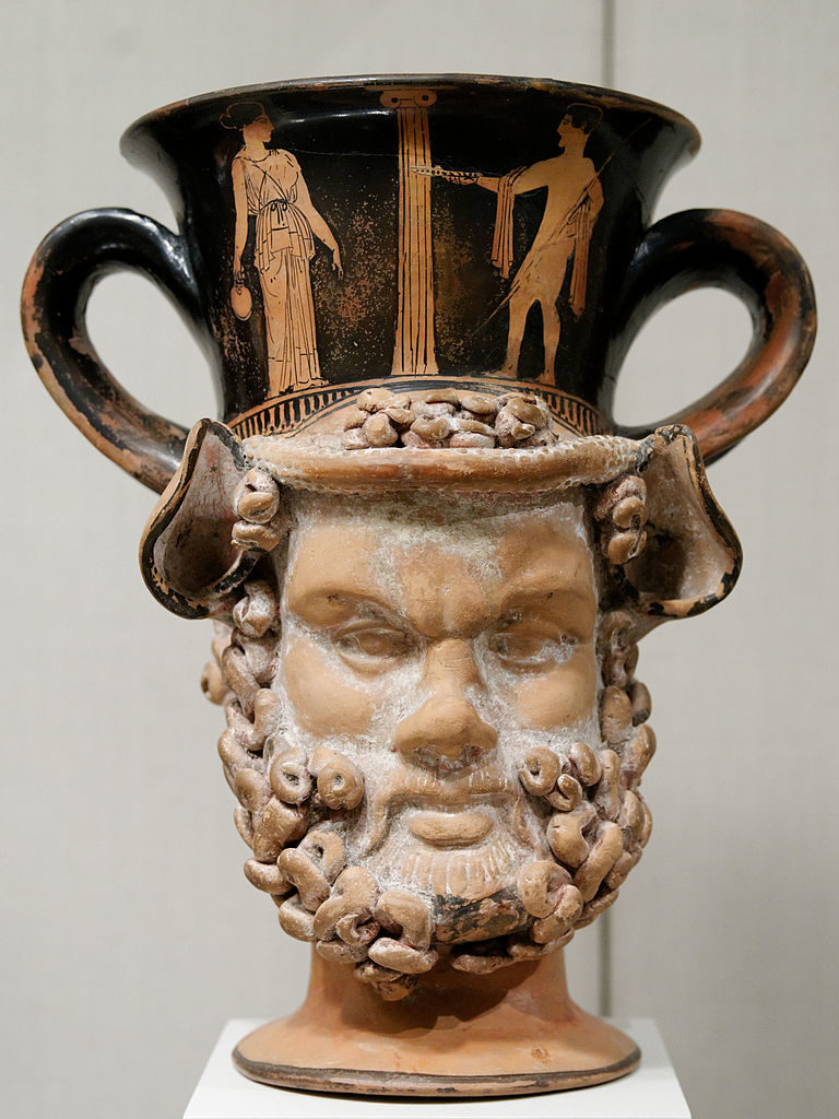 Attributed to Aison and the Spetia Class of head vases. Libation scene. Janus-faced attic red-figure kantharos in the shape of satyr and female heads. Circa 420 BCE, terracotta, 20.5 cm (8 in)